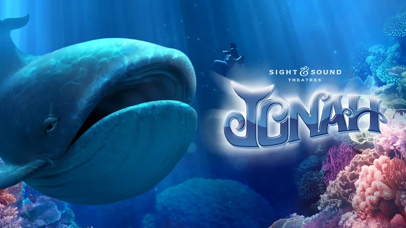 Sight and Sound Theaters Presents Jonah Jonah underwater with a massive whale approaching, surrounded by coral reefs and sea life from Sight & Sound Theatre's JONAH production.
